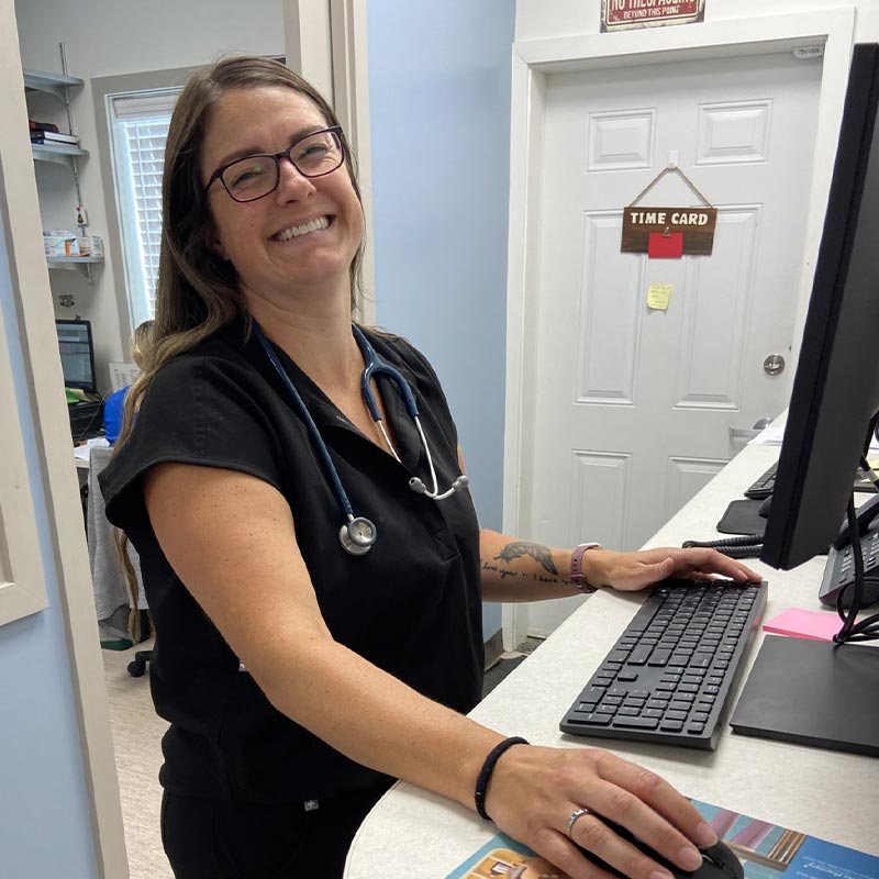 Doctor Smiling While Using Computer