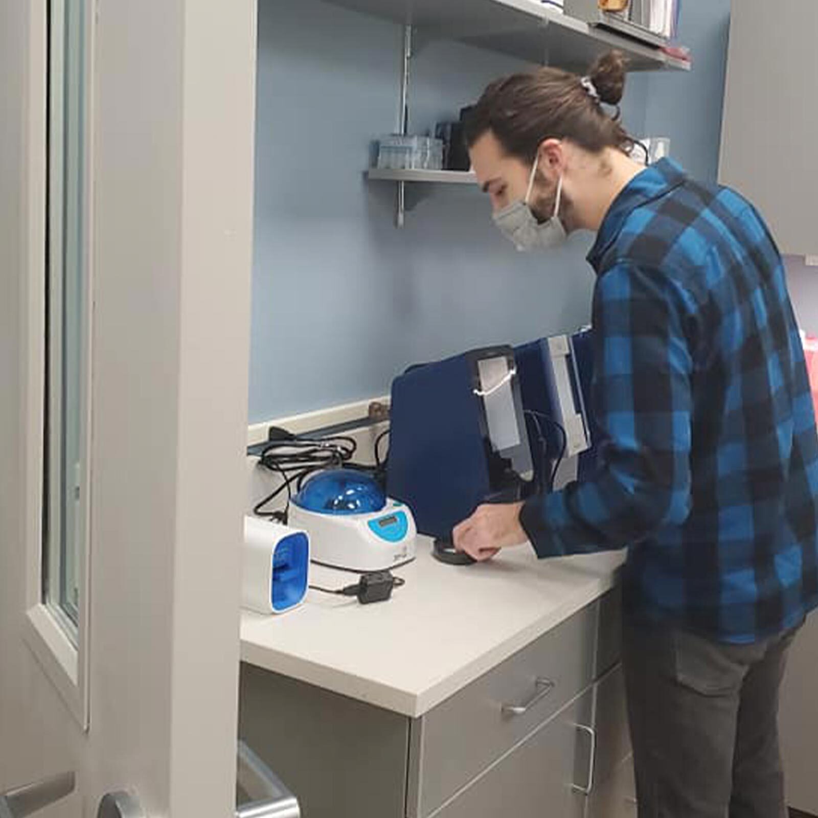 Staff Member Using Diagnostic Equipment In Laboratory